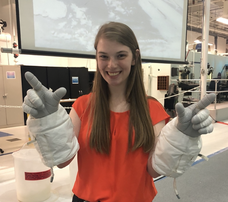 Katelyn is a member of a student team which competes in NASA's Micro-g NExT Challenge every year. Last May, Katelyn and the team traveled to the Johnson Space Center in Houston to test out their designed tool at the NBL. While there, she got to try on a pair of EVA gloves like those used by astronauts for testing.